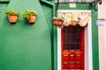 Green wall and wooden door in Burano island, Venice, Italy Royalty Free Stock Photo