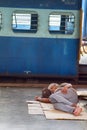 European in India waiting for train like everyone else, sleeping on floor