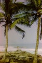 A European lady sitting on rocks near the Atlantic Ocean in Accra, Ghana c.1960