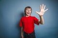 European-looking boy of ten years shows a figure Royalty Free Stock Photo