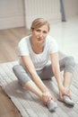 European Looking Woman Over 50 Years Old Doing Yoga at Home in the Living Room.