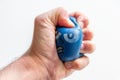 European male hand squeezing an anti-stress ball with the strong fingers shows stress and anger, anxiety and frustration