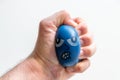 European male hand squeezing an anti-stress ball with the strong fingers shows stress and anger, anxiety and frustration