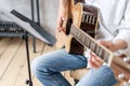 European male posing with acoustic guitar in his hands