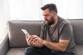 European man with a beard looks at a tablet Royalty Free Stock Photo