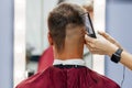 European man is cut by a barber. Men& x27;s haircutting with hair clipper Royalty Free Stock Photo