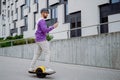european man with electric skateboard. Young handsome man using the phone.