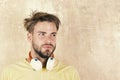 European man have fun time. American handsome bearded guy with headphones. Cheerful teenage boy listening songs via Royalty Free Stock Photo