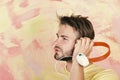 European man have fun time. Cheerful teenage boy listening songs via earphones. American handsome bearded guy with Royalty Free Stock Photo