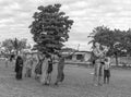 European man launching quadrocopter among african children