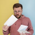 European man looks at gas bills and is surprised at rising prices. Concept of increasing expenses. Royalty Free Stock Photo