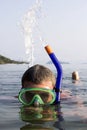 A European man snorkeling blow water on the sea a Royalty Free Stock Photo