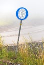 European mandatory snow chain wheels traffic sign in winter on cold foggy morning Royalty Free Stock Photo