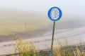 European mandatory snow chain wheels traffic sign in winter on cold foggy morning Royalty Free Stock Photo