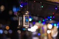 European night Christmas fair lantern soft focus decorative object hanging on roof with blurred unfocused dark outdoor background Royalty Free Stock Photo