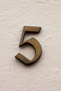 Number 5 germanic vintage antique metal house number on white wall