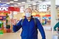 European redbeard man is in protective medical mask in airport