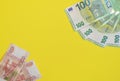 European and Russian Banknotes isolated on a yellow background. Close-up view from above. The concept of competition