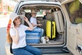 European single-parent family and Jack Russell puppy travel by car. Toddler with his mother and a small dog are sitting