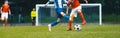 European soccer match between youth teams. Young school boys playing soccer game. Junior competition between players running Royalty Free Stock Photo