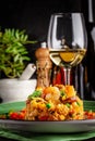 European Spanish cuisine. Paella with shrimps, chicken and coblas chorizo. White wine on the table. Closeup background image