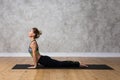 European sporty female, practising Urdhva Mukha Svanasana yoga pose