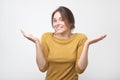 European student woman in gesture of asking over gray background Royalty Free Stock Photo