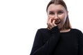 European surprised fair-haired teenage girl dressed in a black turtleneck on a white background