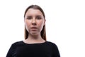 European surprised fair-haired teenage girl dressed in a black turtleneck on a white background