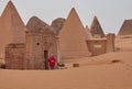 European torist with red shirt at the entrance of a restored pyramid in Meroe, Sudan