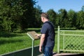 A European tourist reads inscription on the memorial