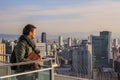 European tourists shooting panoramic view of the city by phone.