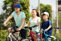 European tourists with son riding bicycles in park Royalty Free Stock Photo