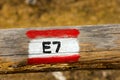 European Trail Sign E7 on a Wooden Pole