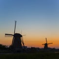 European Travel Destinations. Line of Traditional Romantic Dutch Windmills in Kinderdijk Village in the Netherlands During Golden Royalty Free Stock Photo