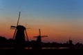 European Travel Destinations. Line of Traditional Romantic Dutch Windmills in Kinderdijk Village in the Netherlands During Golden Royalty Free Stock Photo