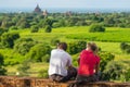 European travellers sitting on pagodas waiting for sunset, Bagan ancient city, Mandalay, Myanmar