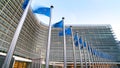 European Union EU flags waving in front of the Berlaymont building, headquarters of the European Commission in Brussels. Royalty Free Stock Photo