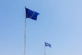 European Union EU and Greece flags is flying in air on blue sky background. Banner, place for text Royalty Free Stock Photo