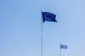 European Union EU and Greece flags is flying in air on blue sky background. Banner, place for text Royalty Free Stock Photo