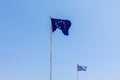 European Union EU and Greece flags is flying in air on blue sky background. Banner, place for text Royalty Free Stock Photo