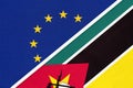 European Union or EU and Mozambique national flag from textile. Symbol of the Council of Europe association