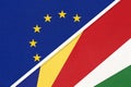 European Union or EU and Seychelles national flag from textile. Symbol of the Council of Europe association