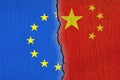 European Union flag and Chinese flag painted on cracked wall , EU and China relations