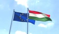 European Union and Hungary flags waving against blue sky. Royalty Free Stock Photo