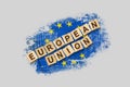 European Union. The inscription on wooden blocks, against the background of the flag of European Union. 3D illustration. Isolated