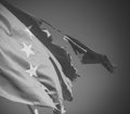 European union twelve star flag torn and with knots in wind on blue sky background, close up. Flag is torn off at side