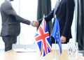 European Union and United Kingdom leaders shaking hands on a deal agreement. Brexit. Royalty Free Stock Photo