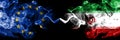 European Union vs Iran, Iranian smoke flags placed side by side. Thick colored silky smoke flags of EU and Iran, Iranian