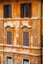 European windows with wooden shutters. Old house exterior. Royalty Free Stock Photo